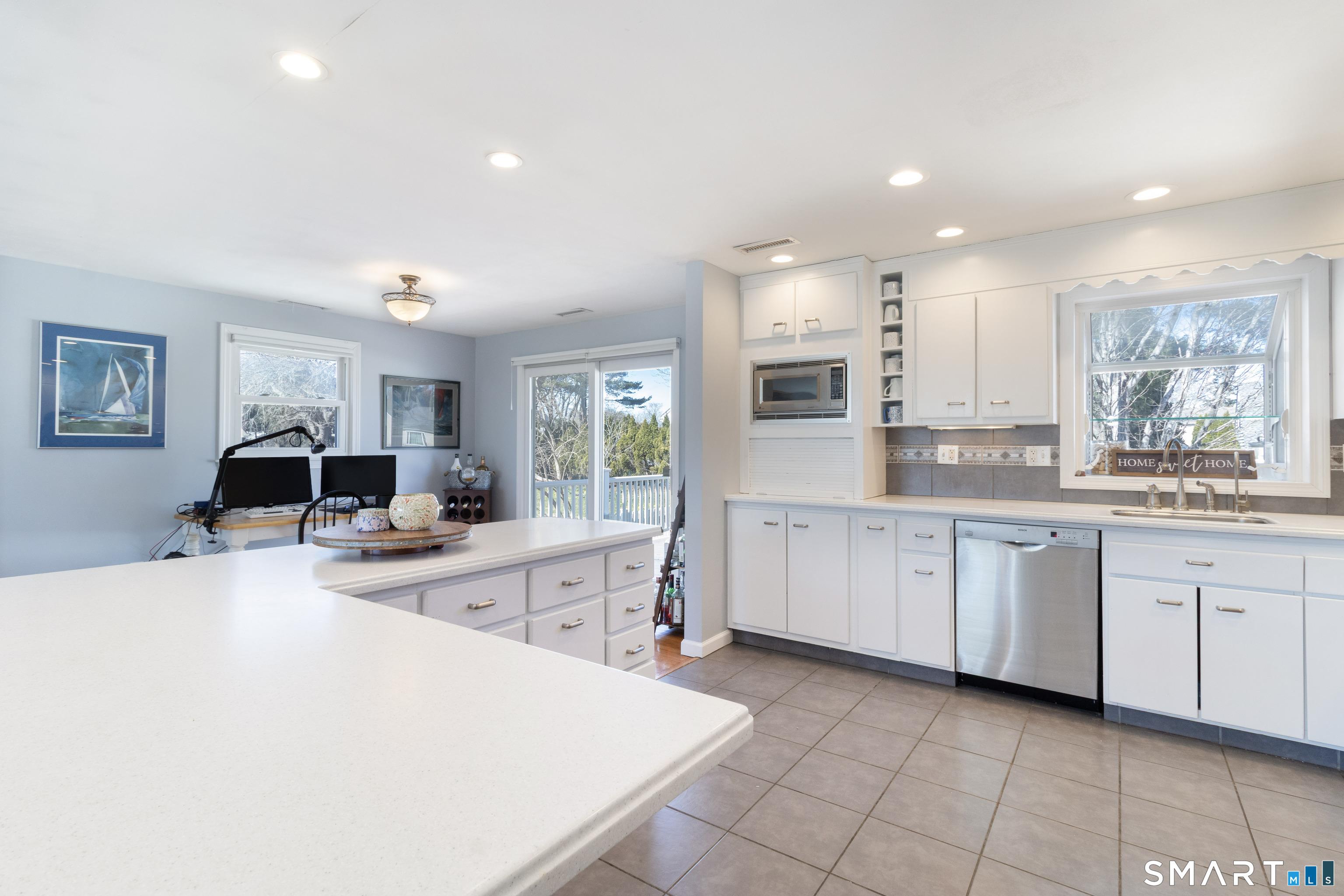 Image 4Kitchen: Kitchen has access to the back deck, fenced yard, and patio.