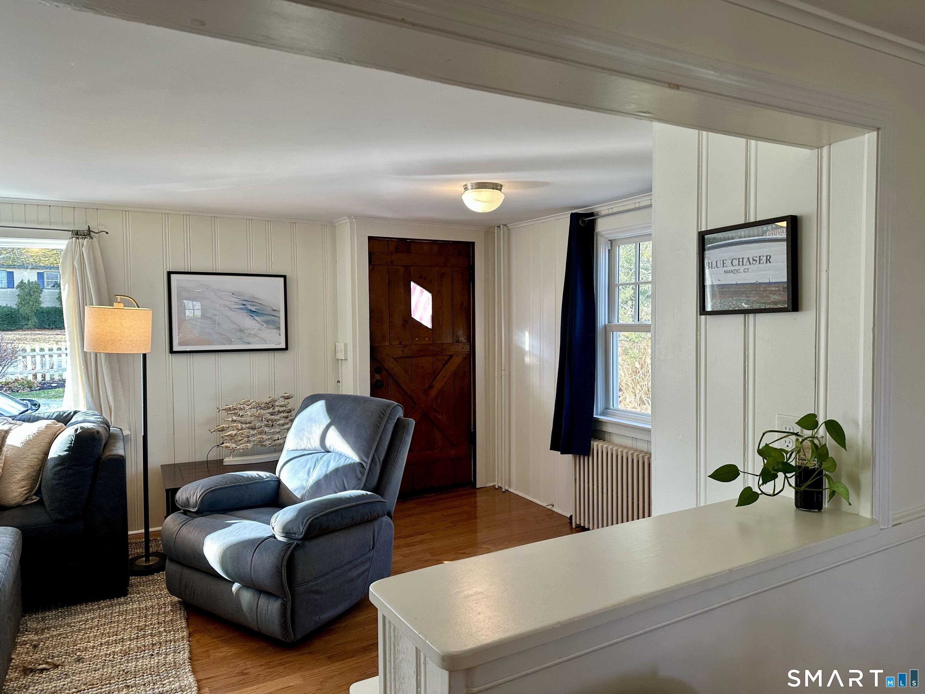 Image 4Living Room: Large living room with Front Entrance Door, Fireplace, lots of windows.