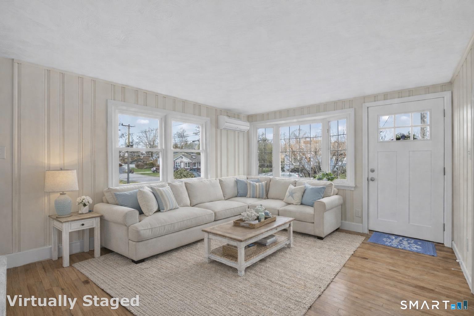 Image 4Living Room: Living room with hardwood floors, a bay window, natural light, and a comfortable layout for everyday living.