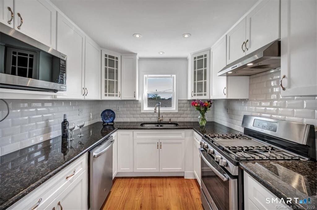 Image 3Kitchen: With Custom Built Cabinets, Granite Counters and Stainless- Steel Appliances