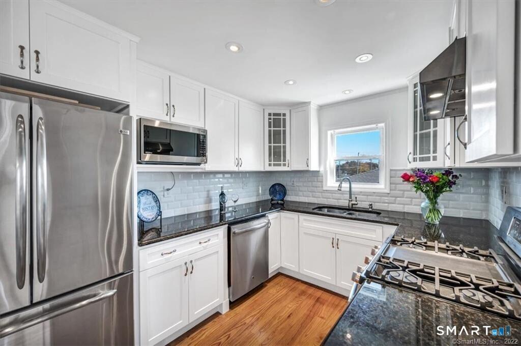 Image 4Kitchen: With Custom Built Cabinets, Granite Counters and Stainless-Steel Appliances