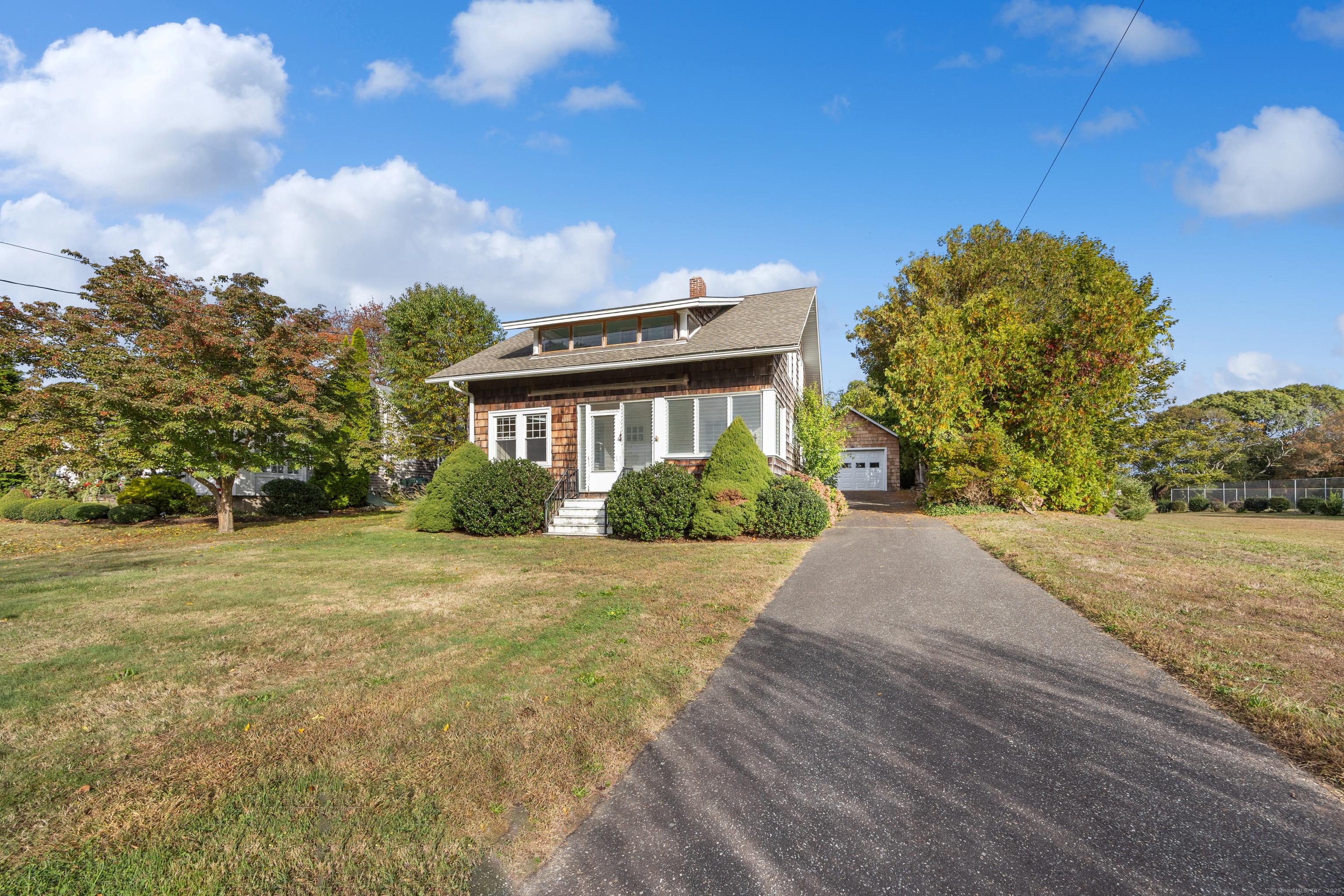 Image 4Front of House: Large Driveway with detached garage