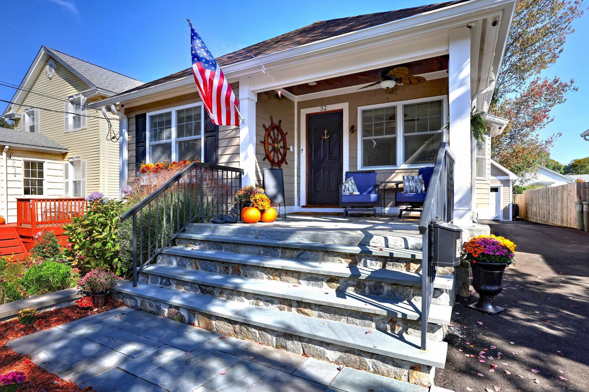Image 2Front of House: Front Porch 11x11 with Bronze Glass railing & IPE railing, Stone/Cement Flooring x 8", Textured Hardy Board siding with Textured PVC Trim & Commercial size gutters. The Captains Wheel will stay!