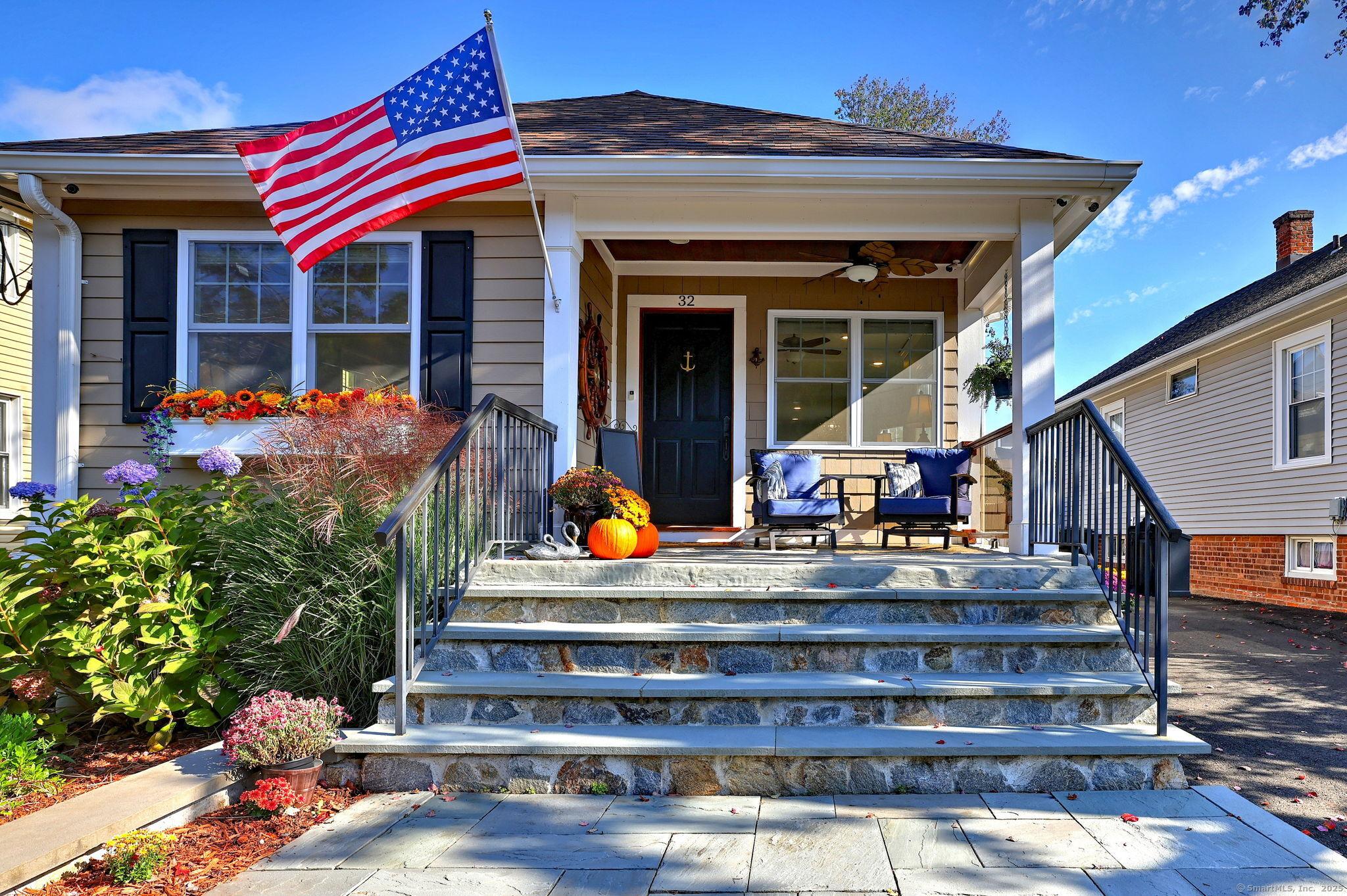 Image 3Front Yard: The stairs are stone with cement base with wide stairs. There are new Iron Rod railings on each side of staircase. Bluestone patio and bluestone wall. Never a dark porch with the automated up-lighting around top front porch.