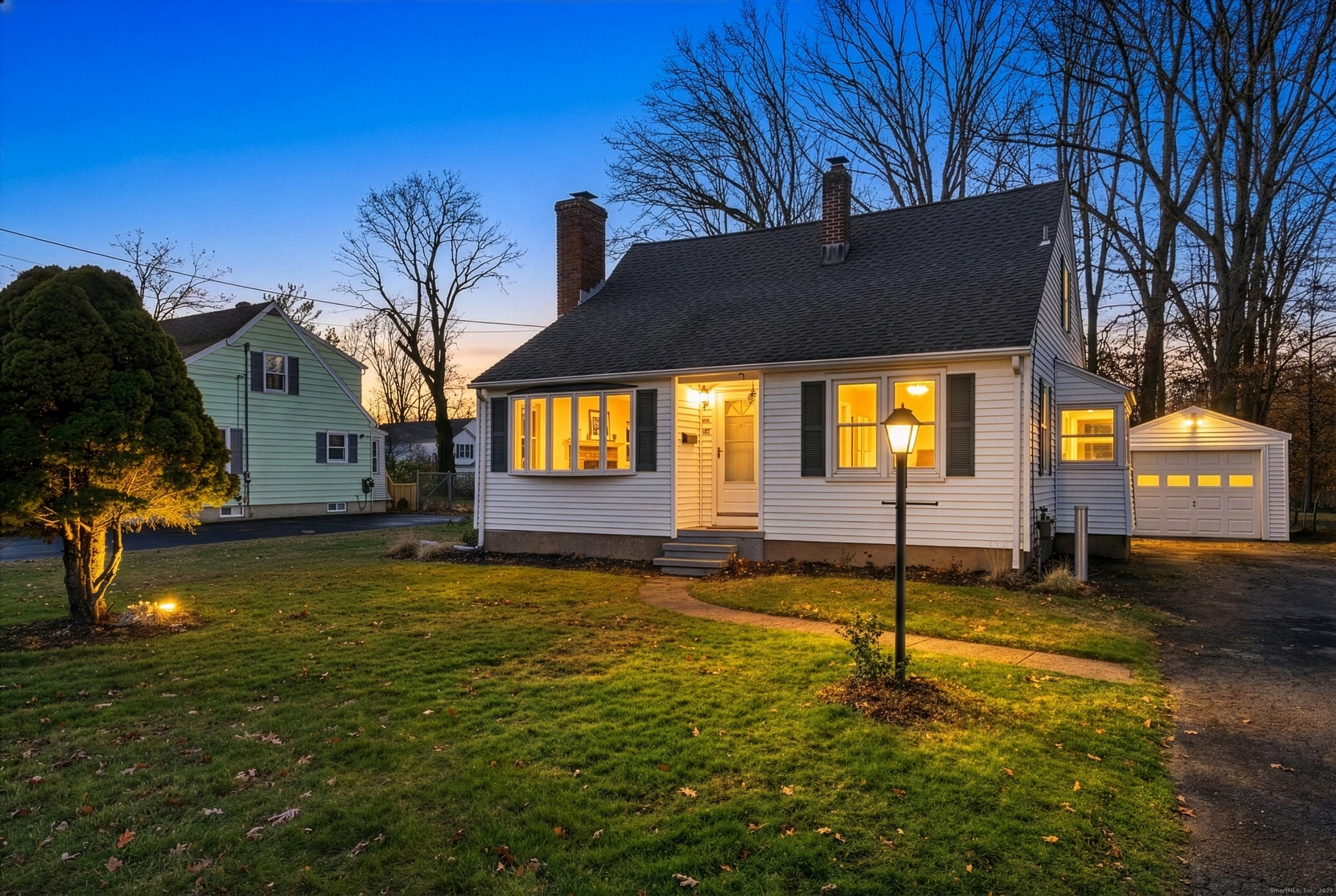 Image 1Front of House: Twilight view of front exterior