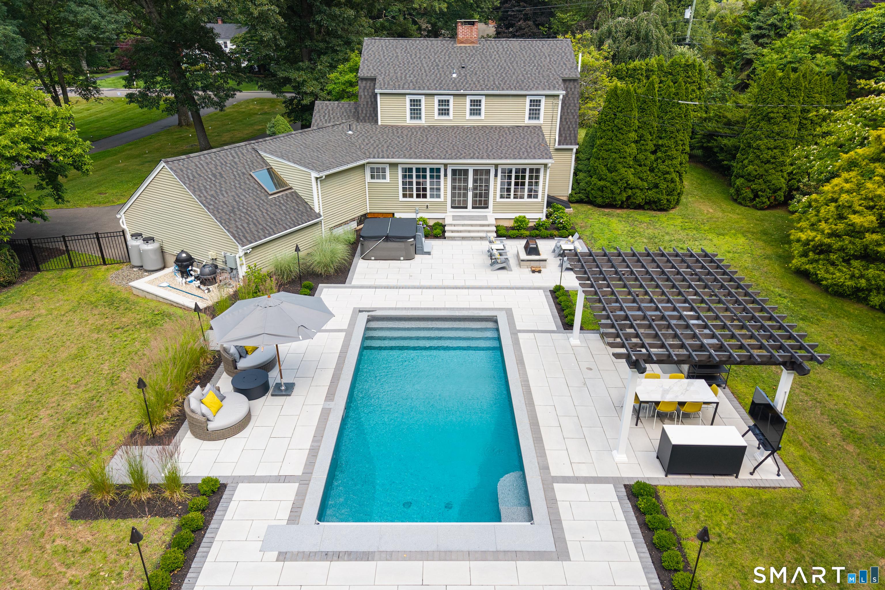 Image 2Swimming Pool: Your private backyard retreat was designed for unforgettable entertaining, featuring a heated saltwater pool, premium hardscaping, and beautifully appointed outdoor living spaces.