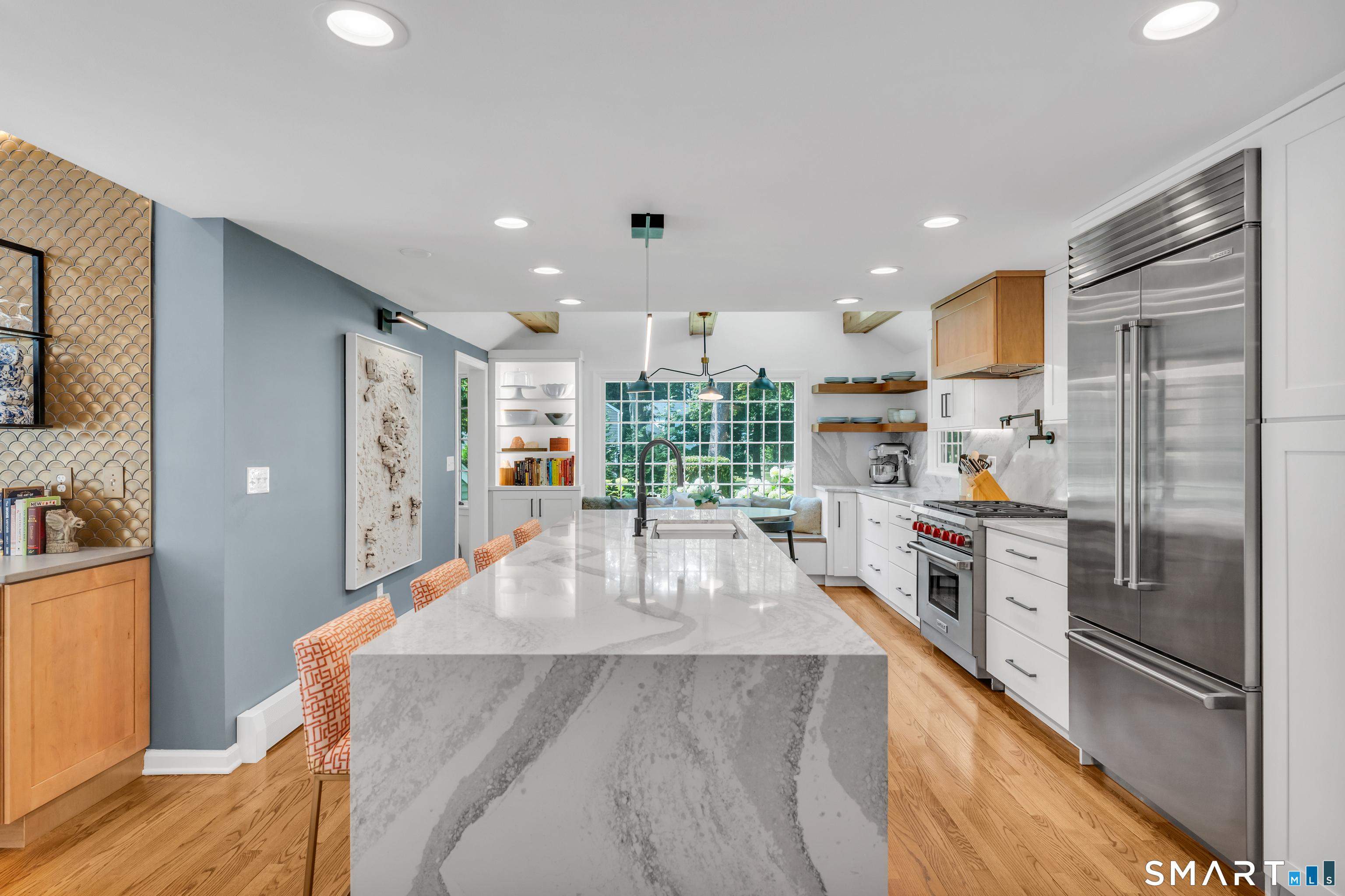 Image 4Kitchen: The heart of the home. This award-winning kitchen, recognized with the 2023 HBRA Best Kitchen Award, pairs stunning Cambria Southport quartz with professional-grade Wolf, Sub-Zero, and Fisher & Paykel appliances for an unparalleled culinary experienc