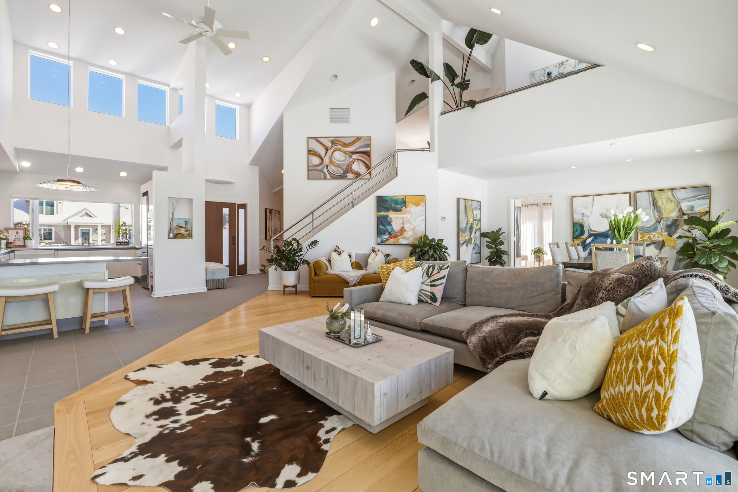 Image 4Living Room: Front foyer with dramatic entrance reveals two story ceiling, sleek lines and a contemporary style. Open floor concept on the main level. Staircase to the leads to the second level.
