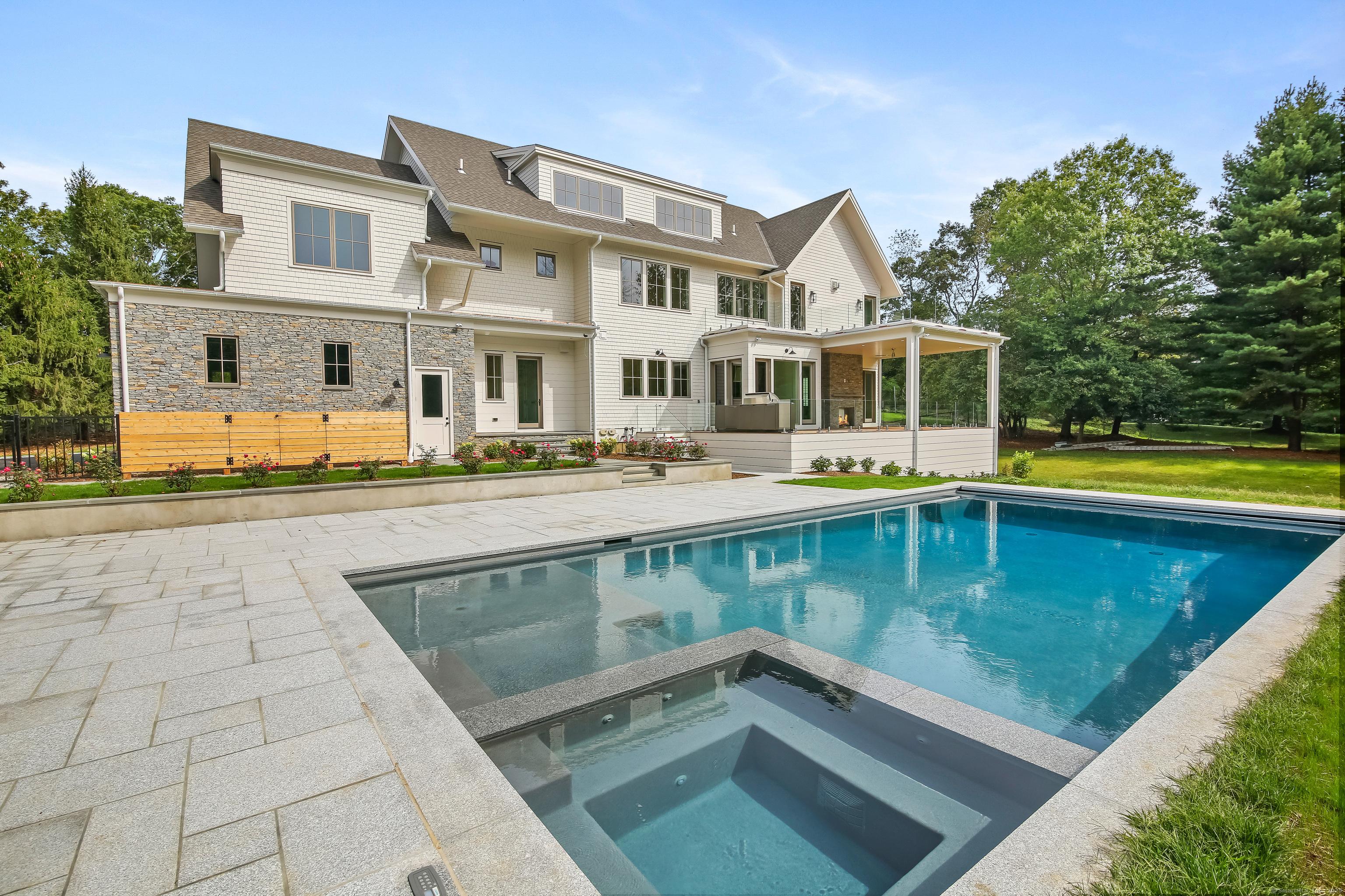 Image 4Back of House: Pool with internal spa and sunning platform just steps from the covered porch and dining area