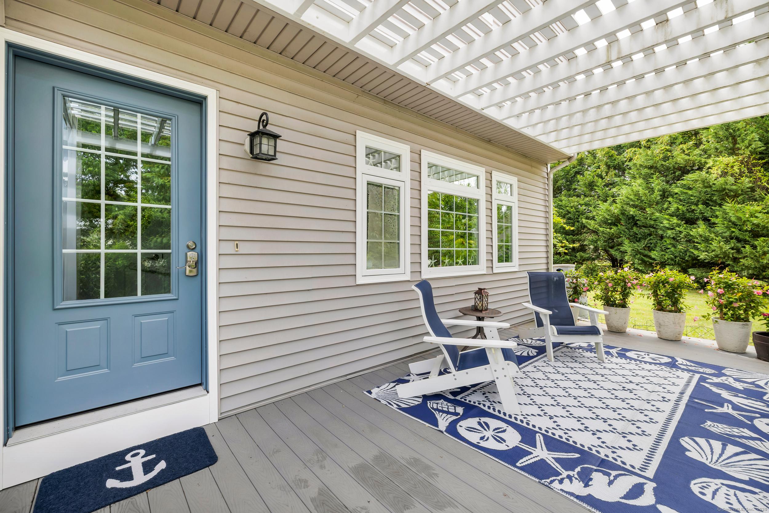 Image 4Front Door: Home offers a lovely approach with curb appeal, surrounded by manicured lawns, beautiful gardens and mature trees and plantings. A charming front porch greets visitors.