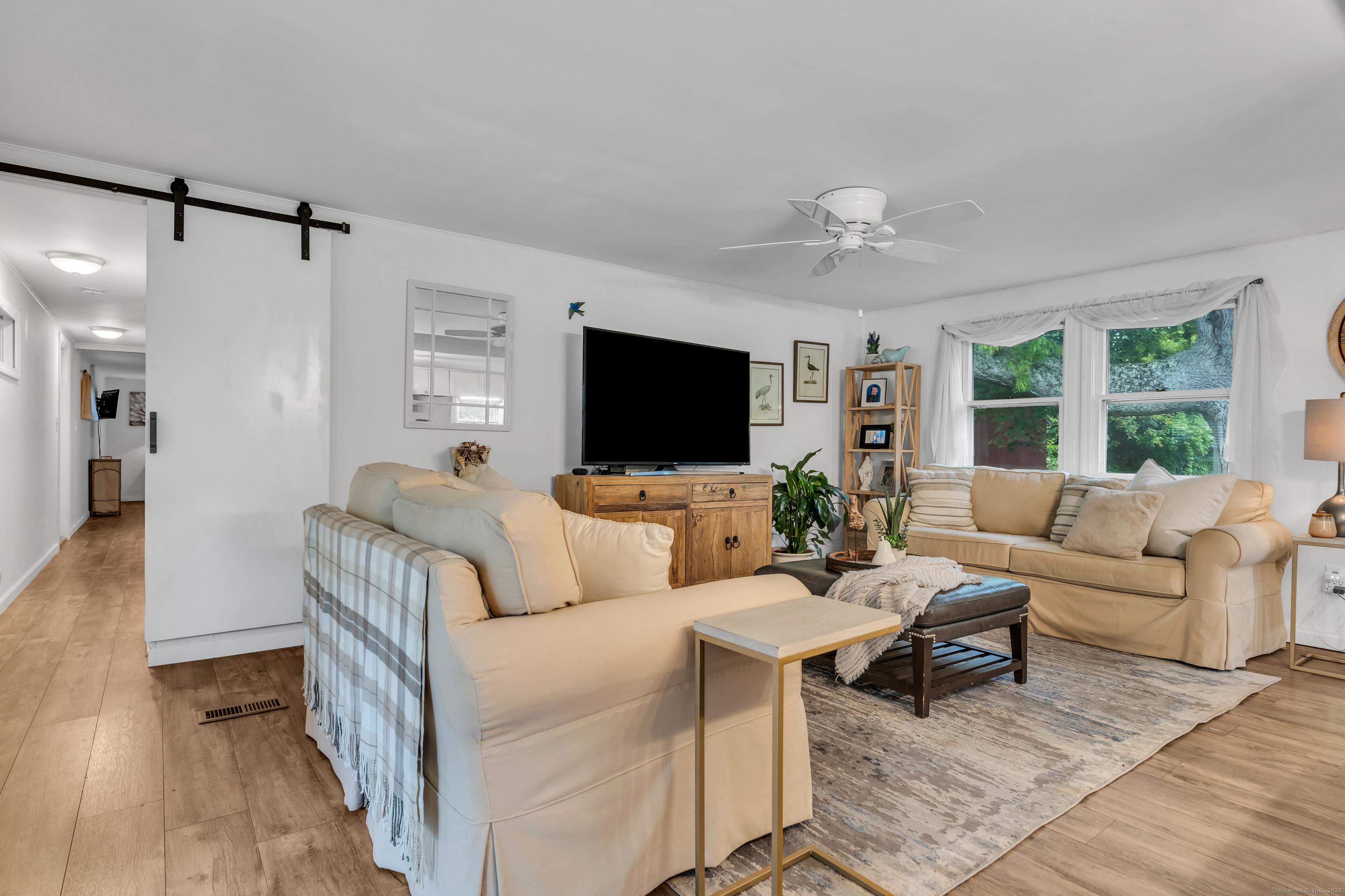 Image 2Living Room: Spacious Living Area with Sliding Barn Door to Sleeping Area