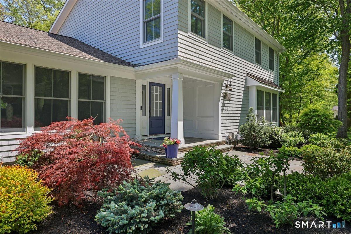 Image 3Front of Structure: Lovely curb appeal with a covered front porch entry that warmly welcomes guests and sets the tone for the inviting home beyond.