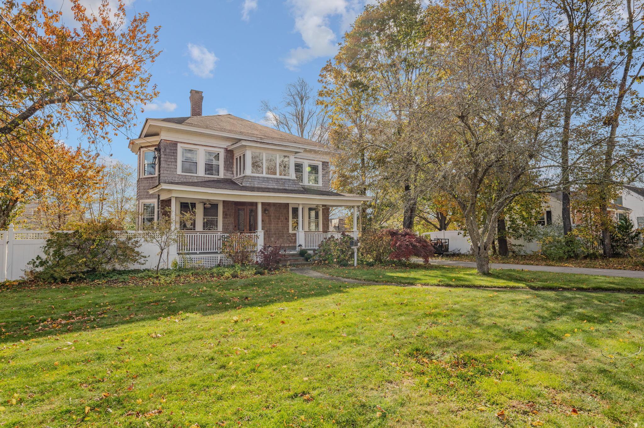 Image 1Front Yard: Spacious front yard framed by majestic mature trees creates outstanding curb appeal