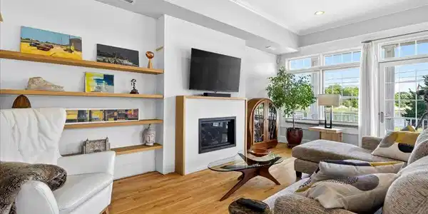 Image 3Living Room: The living room is bathed in light from the walls of windows and sliders.