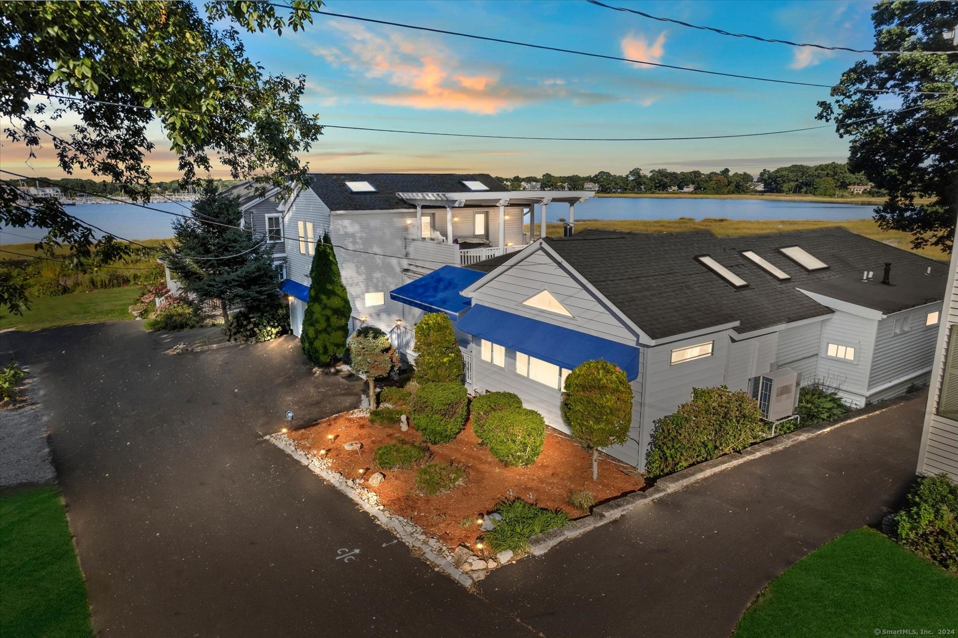 Image 2Front of House: Front of House is inviting with new awnings and beautiful water views