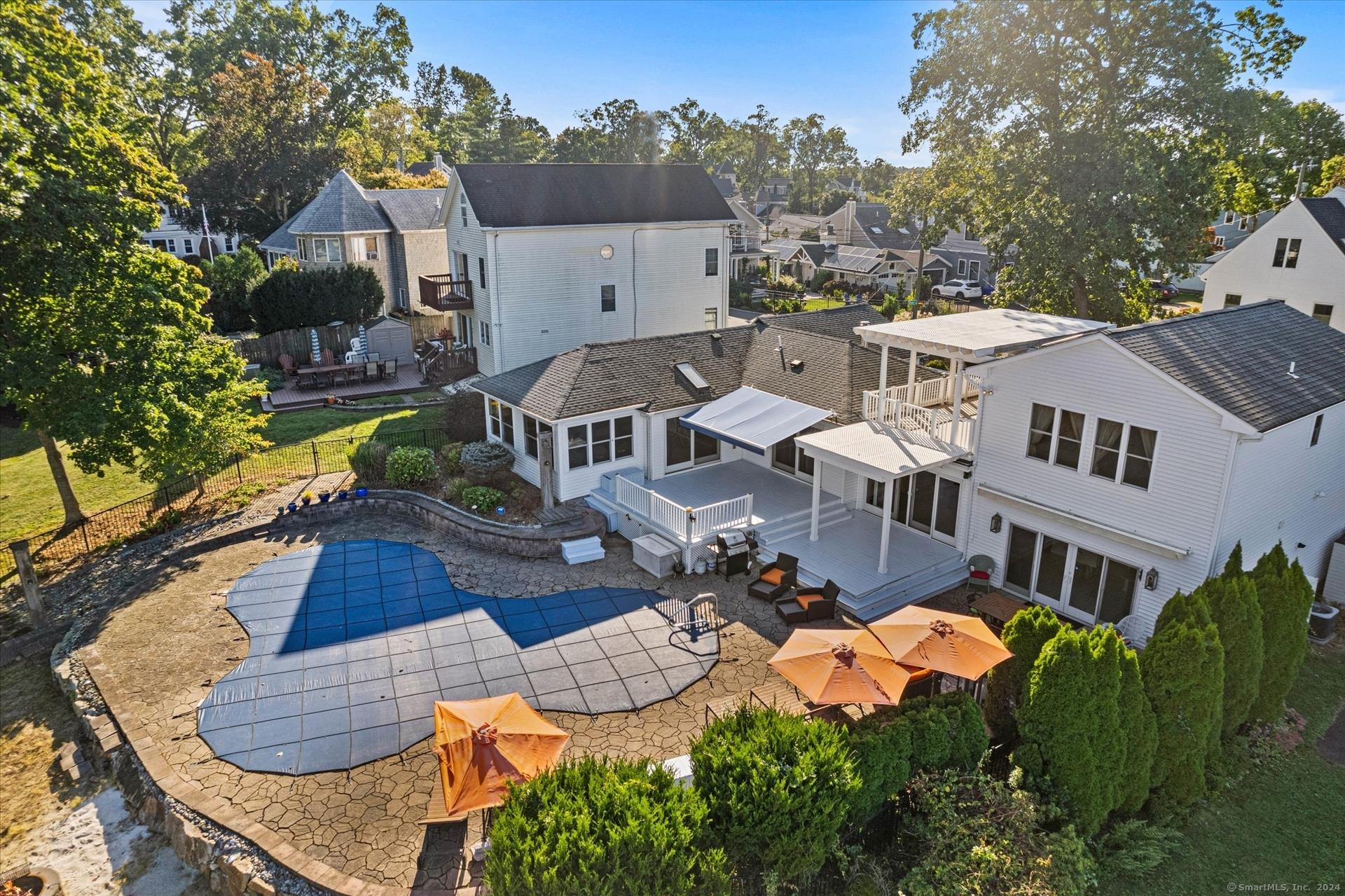 Image 3Back of House: Back of this house shows the inground pool with spacious patio and outdoor entertaining features.