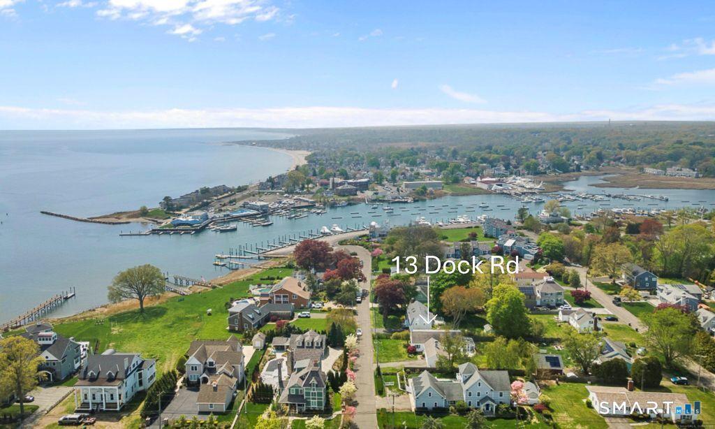 Image 1: A stunning aerial view of a charming coastal neighborhood centered around 13 Dock Road