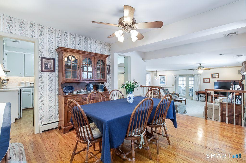Image 4: Bright and inviting dining area featuring warm hardwood floors and an open layout ideal for entertaining.