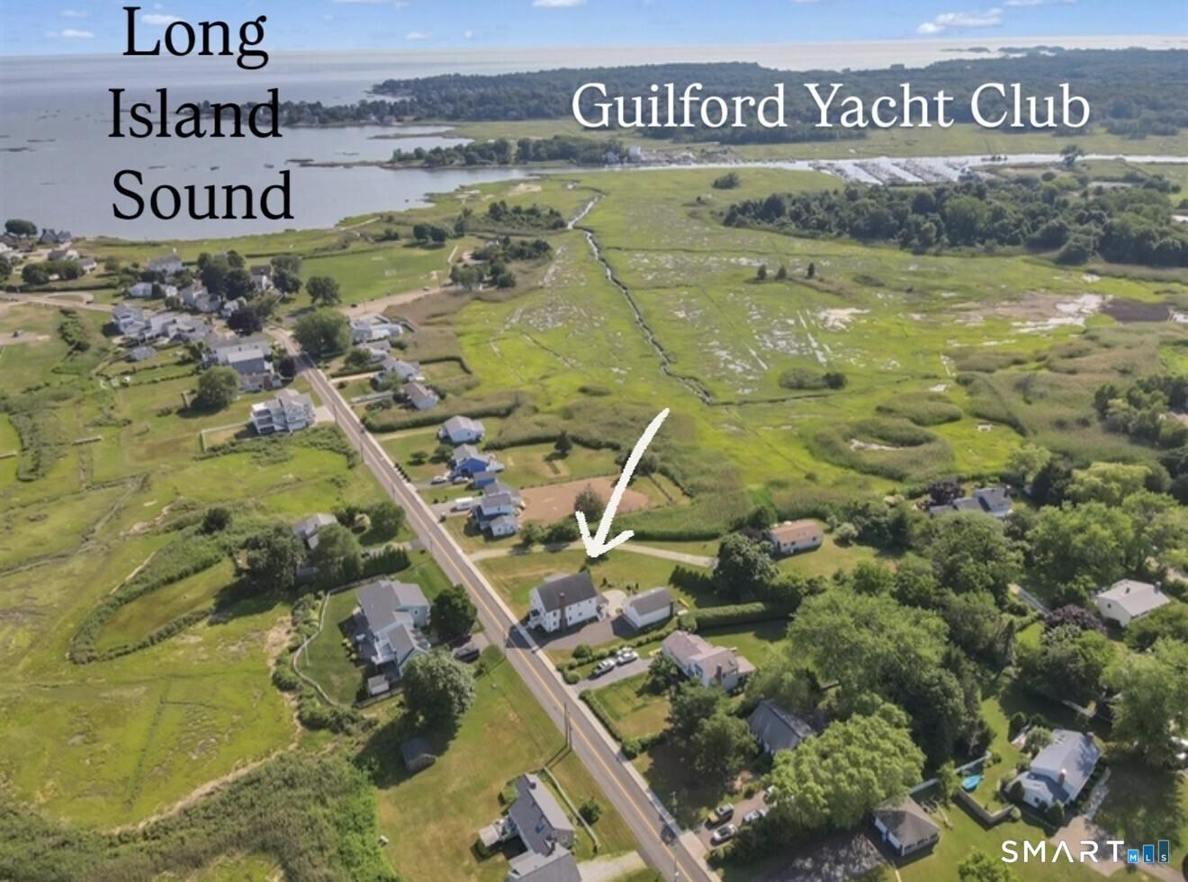 Image 3Aerial View: Aerial photo shows location with close proximity to the beach and Guilford Yacht Club. A rare opportunity to enjoy coastal living just moments from the water, boating, and town amenities