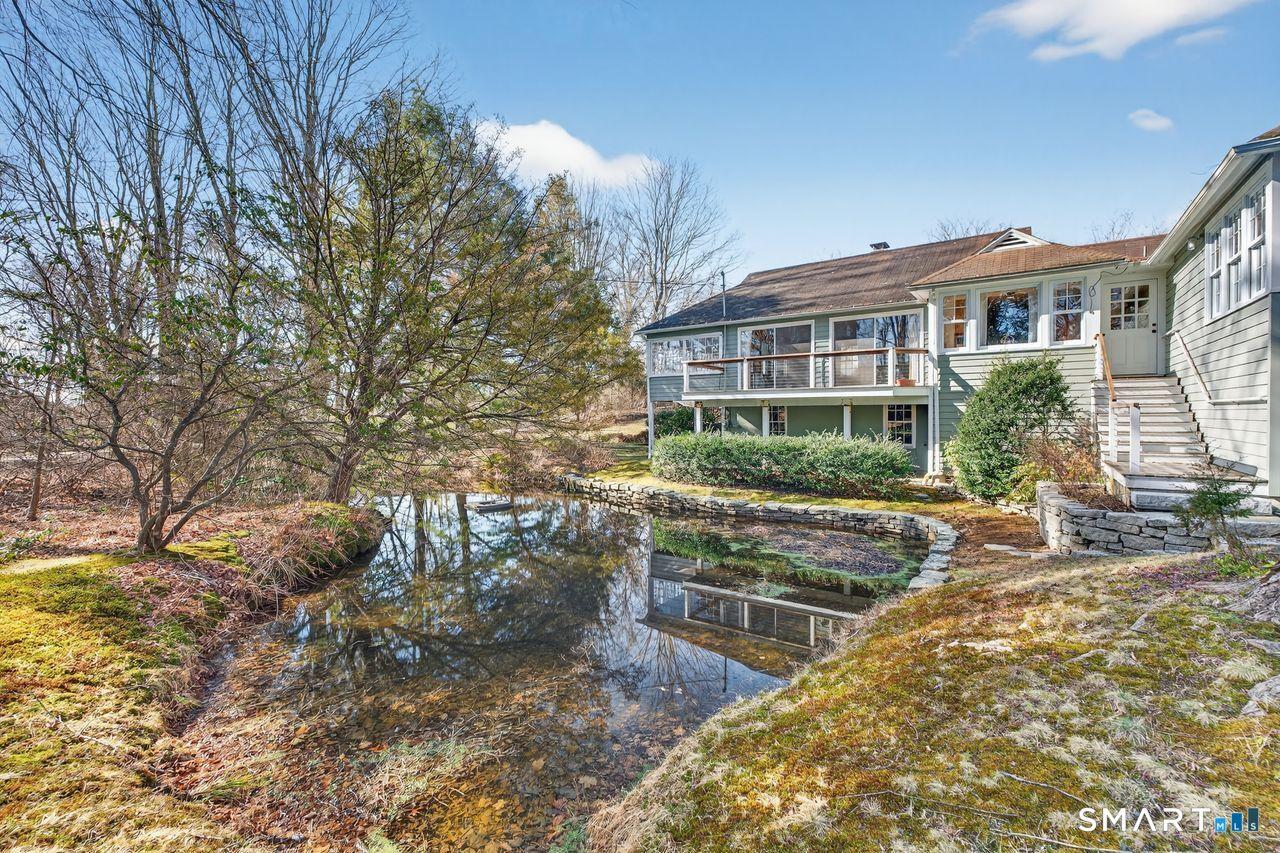 Image 4: This is the primary entrance to the home. It has a wonderful porch that overlooks this pond which was used to hold oysters until they were uploaded onto ships in the Long Island Sound.