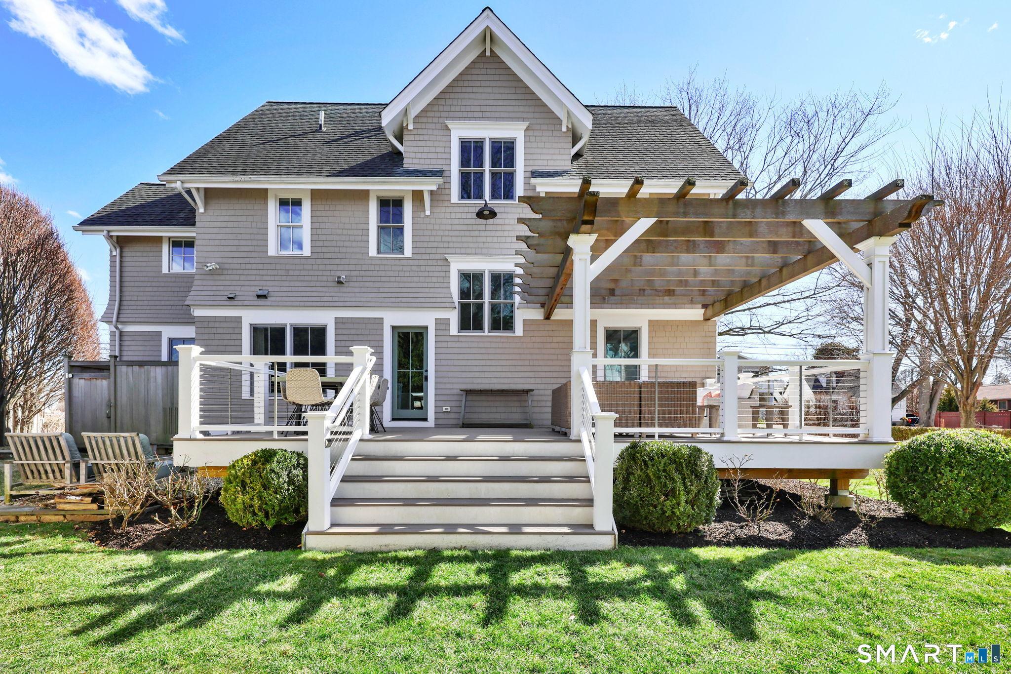 Image 4Back of House: Large porch with Pergola and plenty of space to entertain and relax
