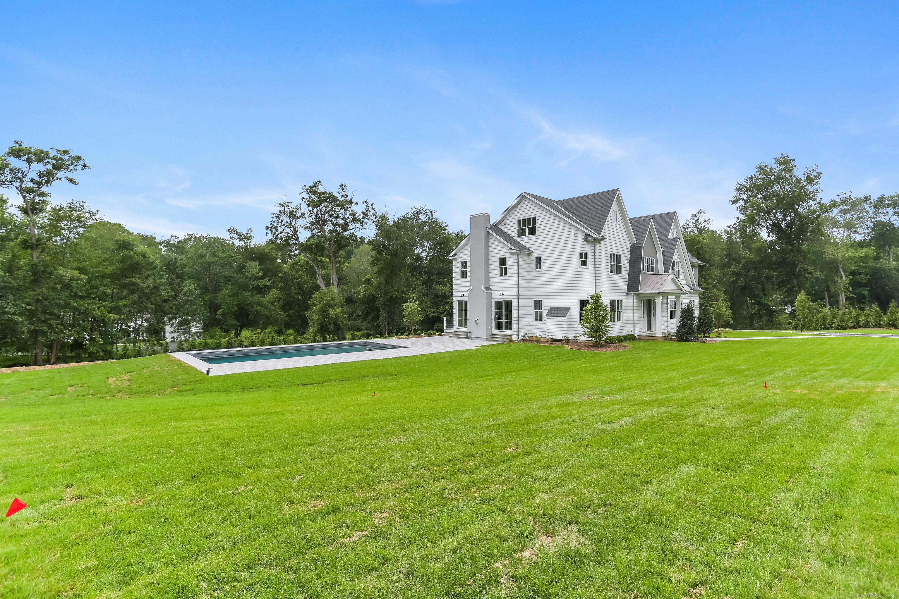 Image 2Side Yard: Beautifully sited on 2 private acres, this home has a salt water pool
