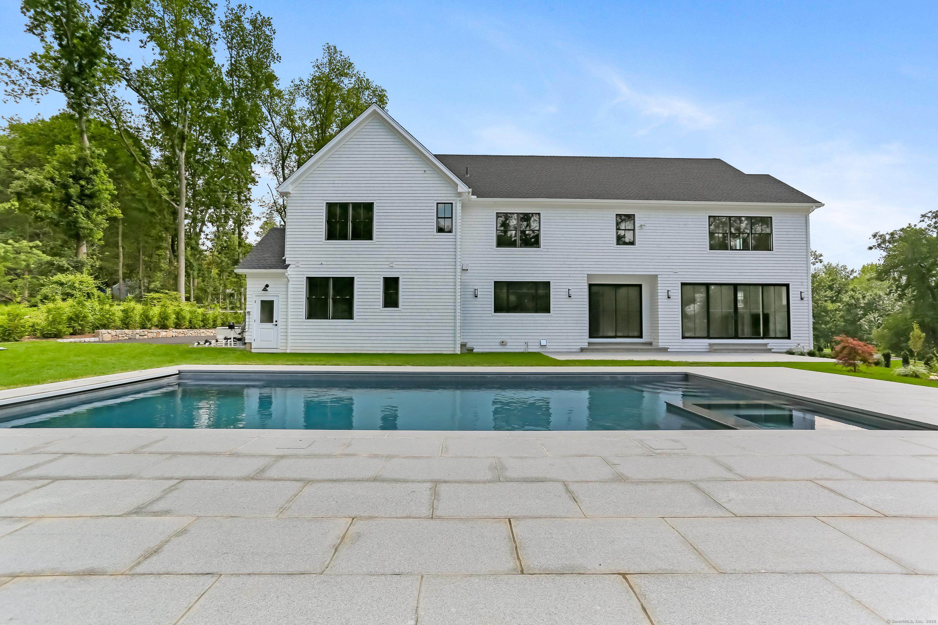Image 2Back of House: Large yard and a salt water pool with granite patio
