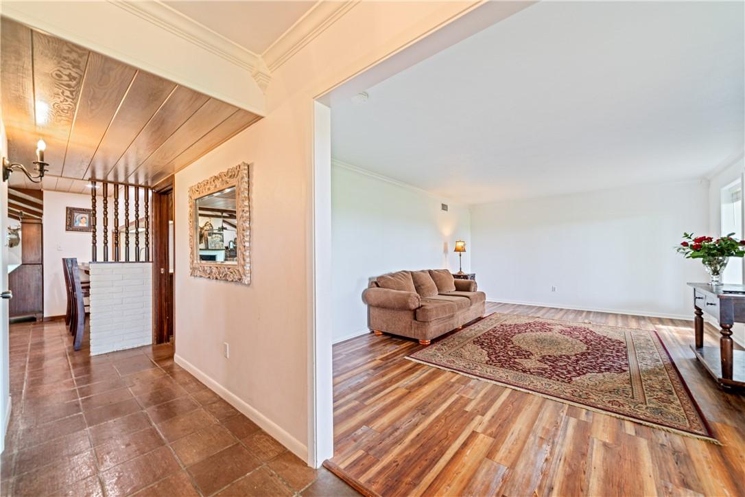 Image 4: Spacious formal living room featuring wood-look fl