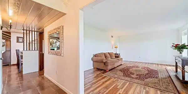Image 4: Spacious formal living room featuring wood-look fl