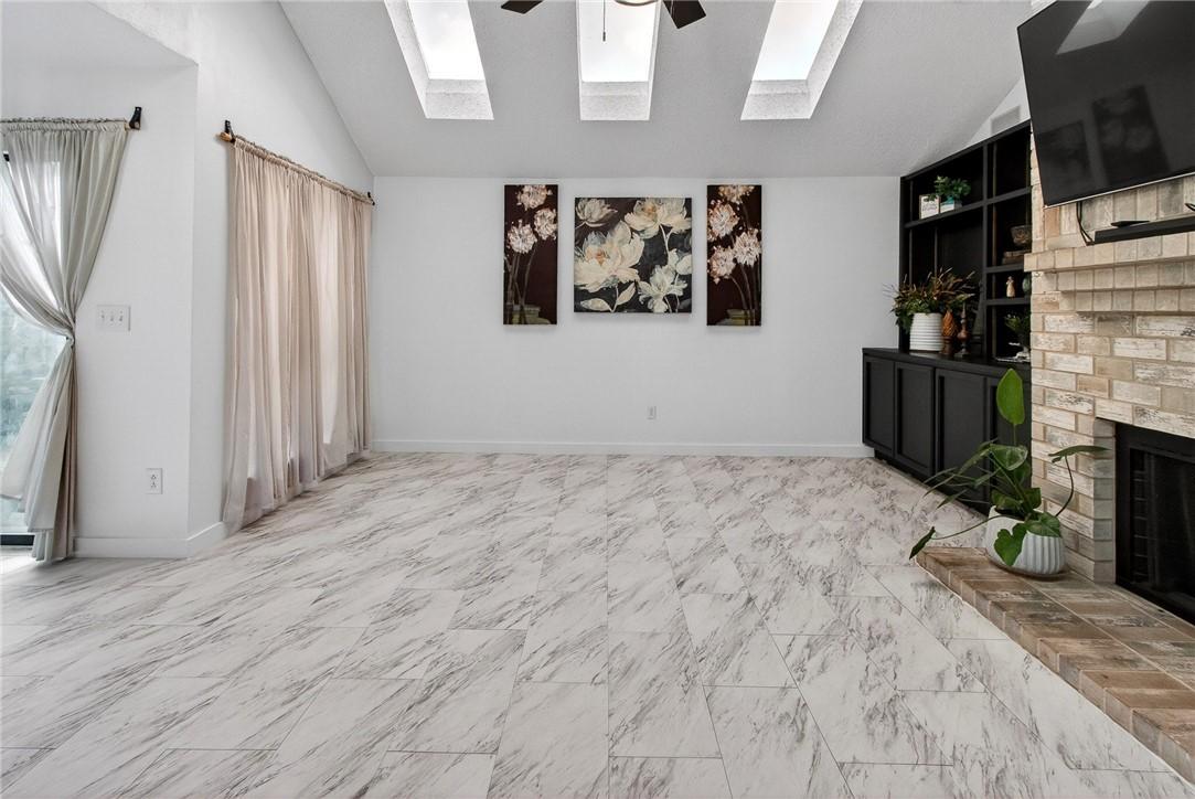 Image 4: The vaulted ceiling and skylights fill the space w