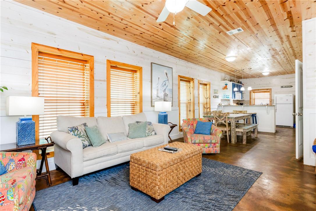 Image 4: The living room is spacious with lots of natural l