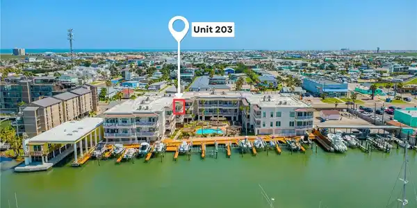 Image 2: Unit 203, building, neighborhood and boat slips