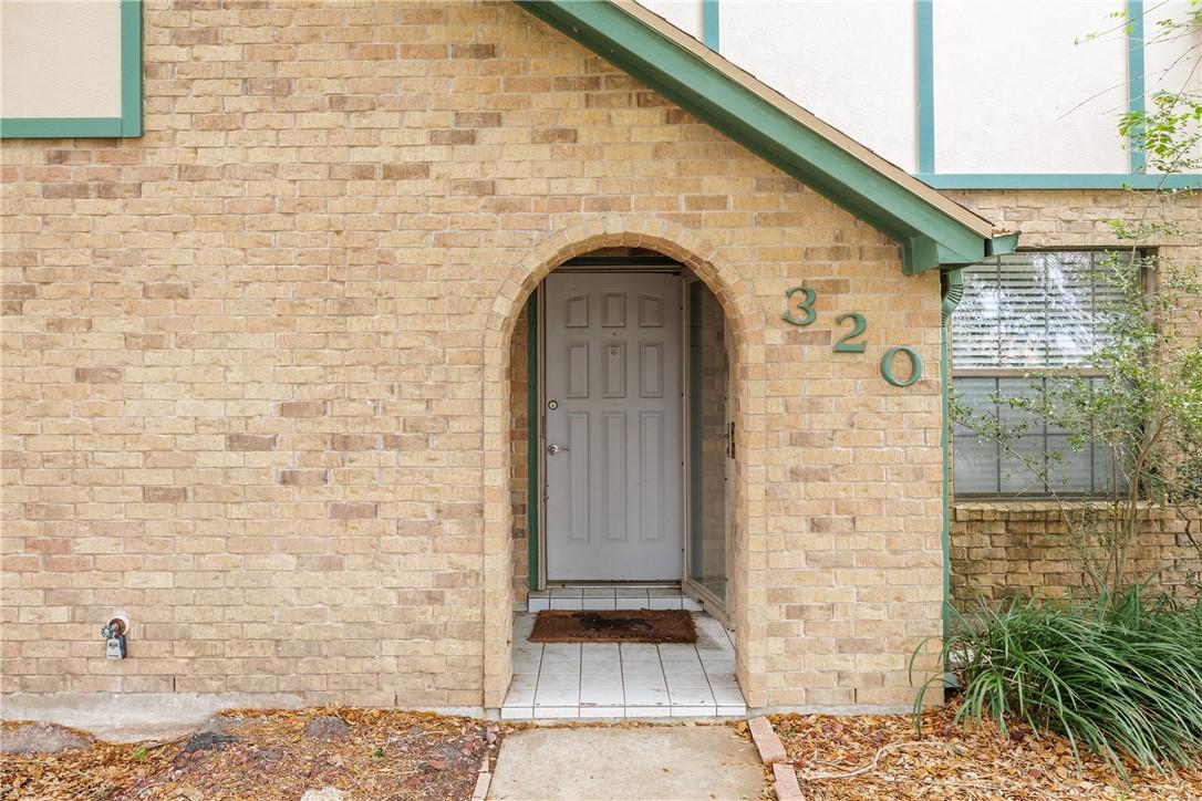 Image 2: A charming arched brick alcove creates a sheltered