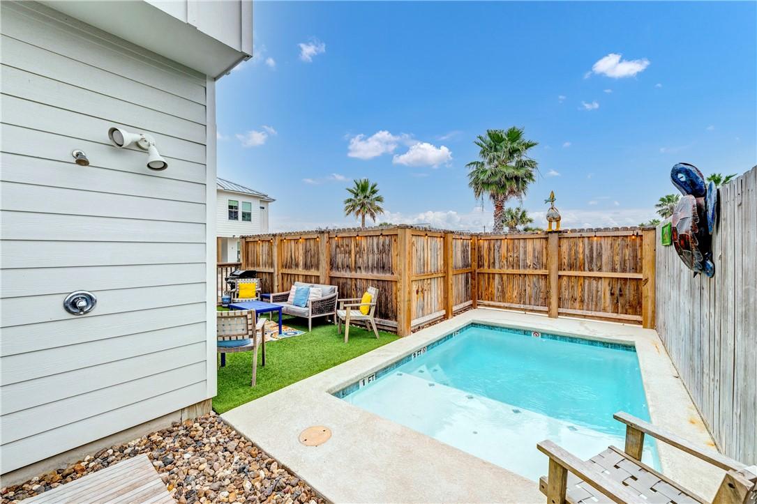 Image 4: Outdoor shower, pool and green space.