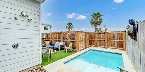 Image 4: Outdoor shower, pool and green space.