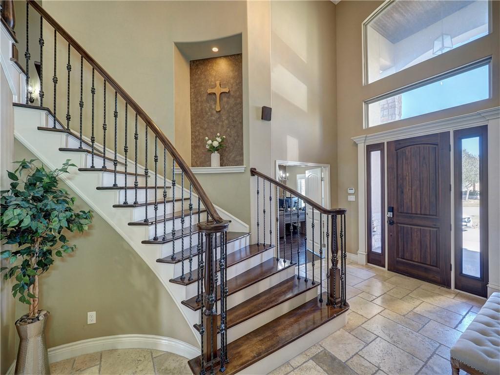 Image 4: Entrance with curved staircase and wrought iron b