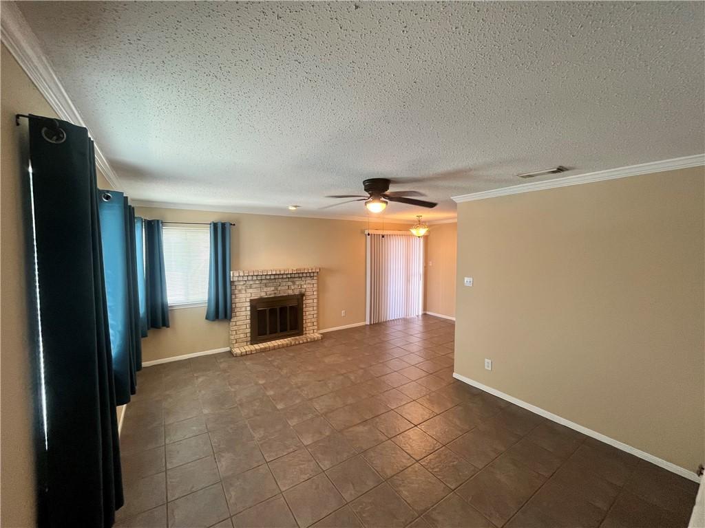 Image 3: Open living and dining with fireplace