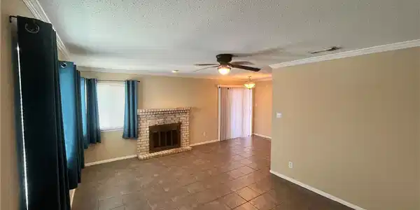 Image 3: Open living and dining with fireplace