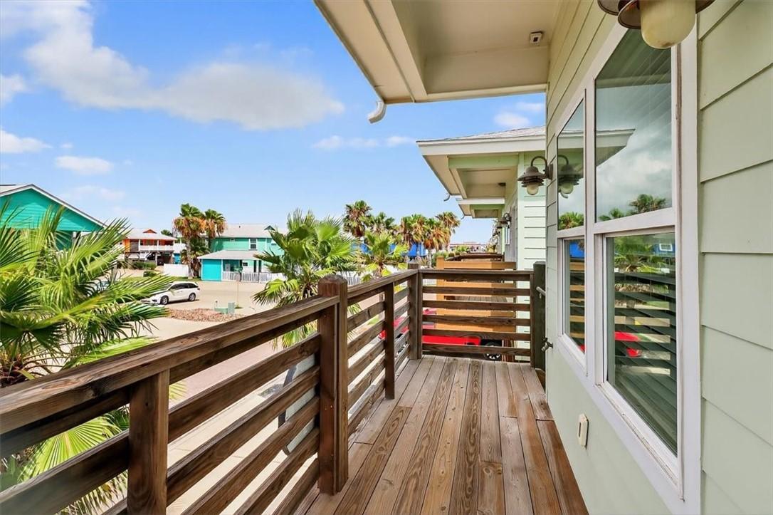Image 3: Charming front deck offers a cozy spot to relax an