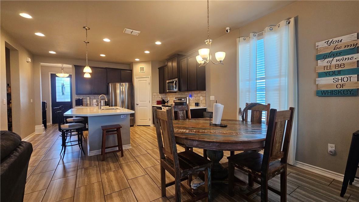 Image 4: The dining area has a chandelier.