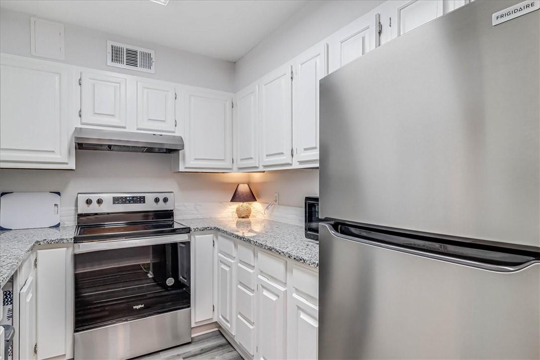 Image 4: Cabinets painted white.