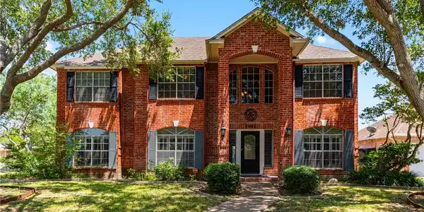 Image 2: Gorgeous two-story brick elevation featuring lush