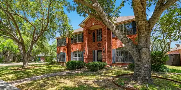 Image 3: Generous corner lot with mature trees and charming