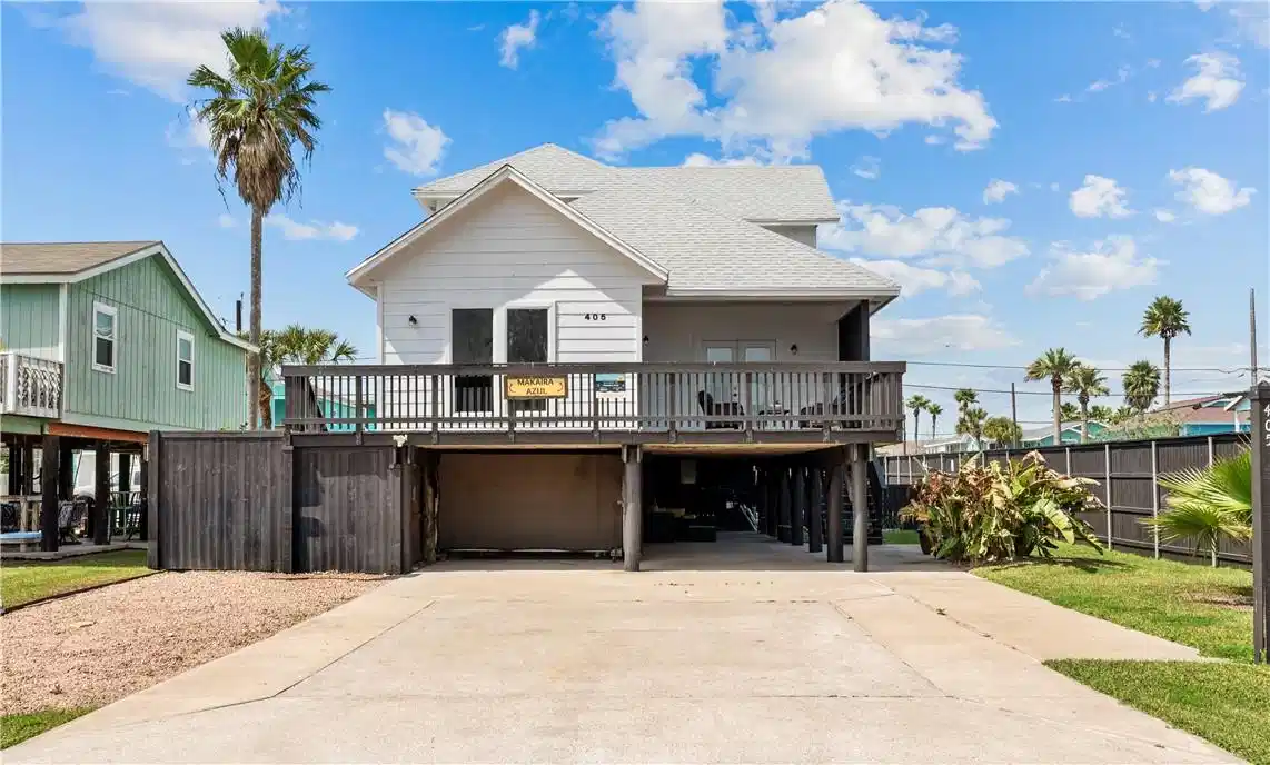 Image 1: Front of home with tons of parking.