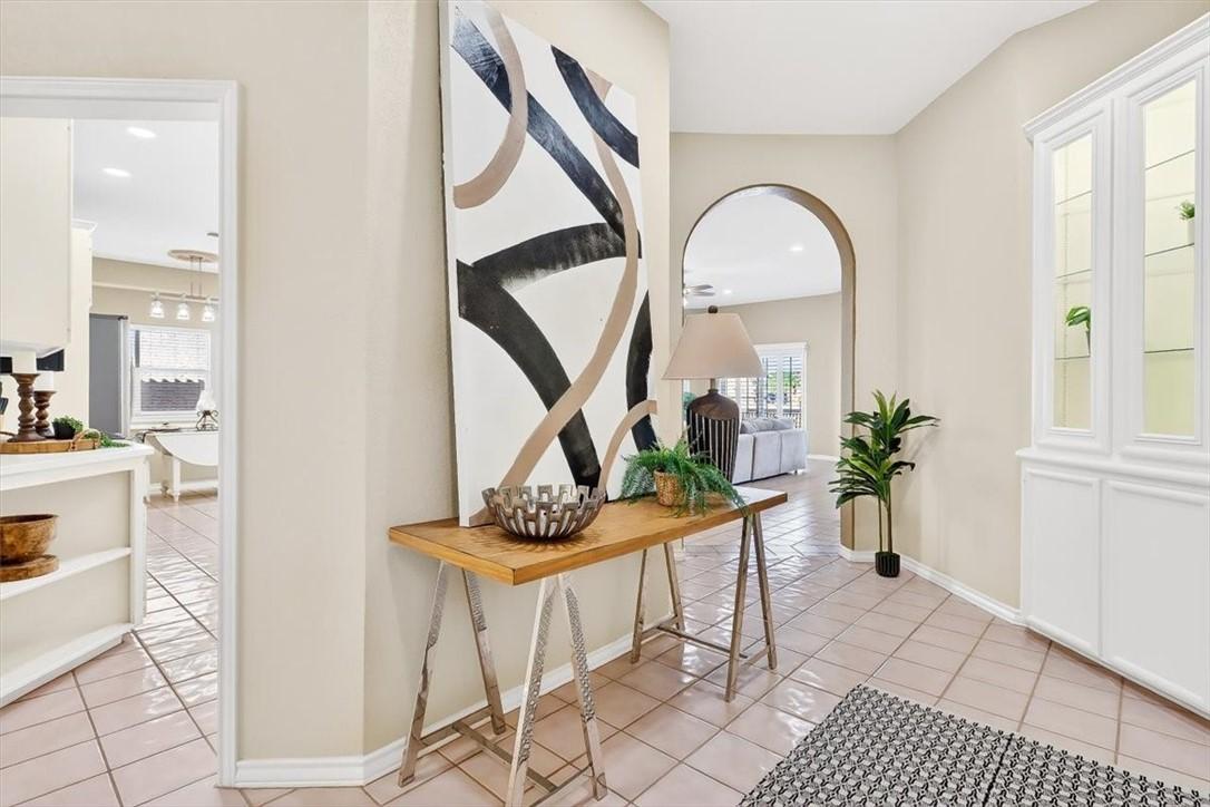Image 3: Step inside to the inviting foyer with kitchen to