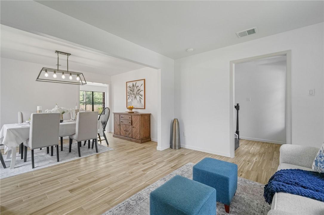 Image 4: Front sitting room flows into the formal dining ar