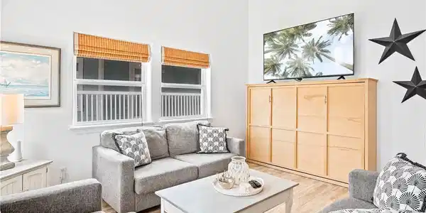 Image 4: Living room features a custom full size murphy bed