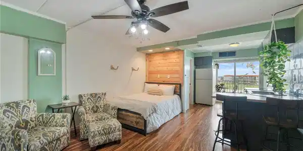 Image 3: Living and sleeping area with comfy seating and ba
