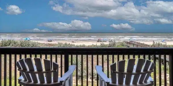 Image 3: private balcony with 6 lounging chairs and table.