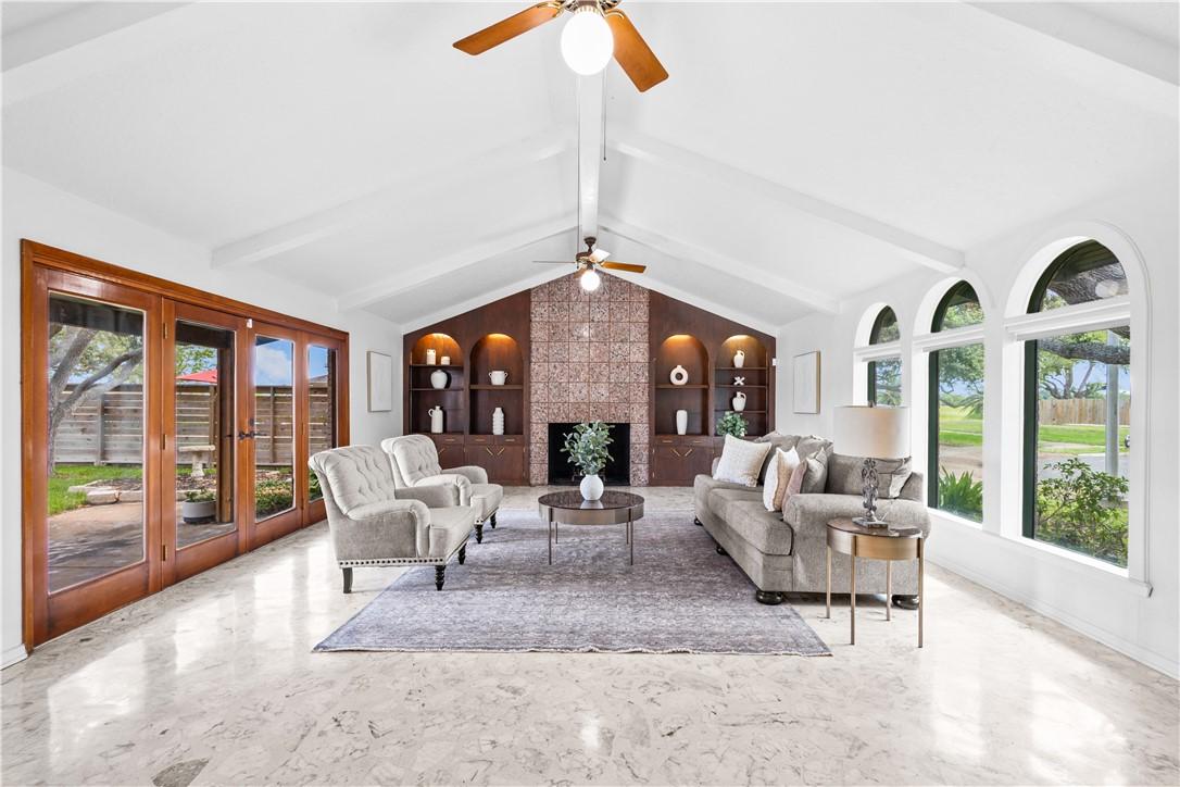 Image 3: Gather around the fireplace in this inviting main